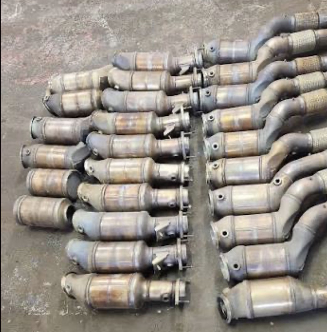 Rows of OEM catalytic converters organized for sale to ES Cores LLC